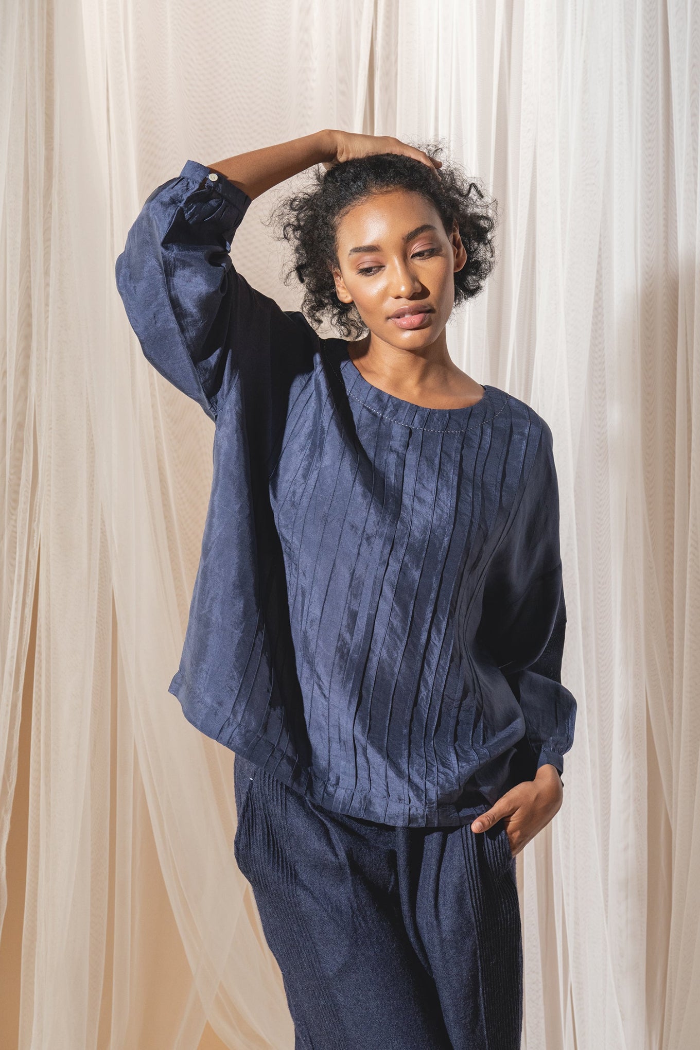 DVE Collection Mahira pintucked silk top in blue.
