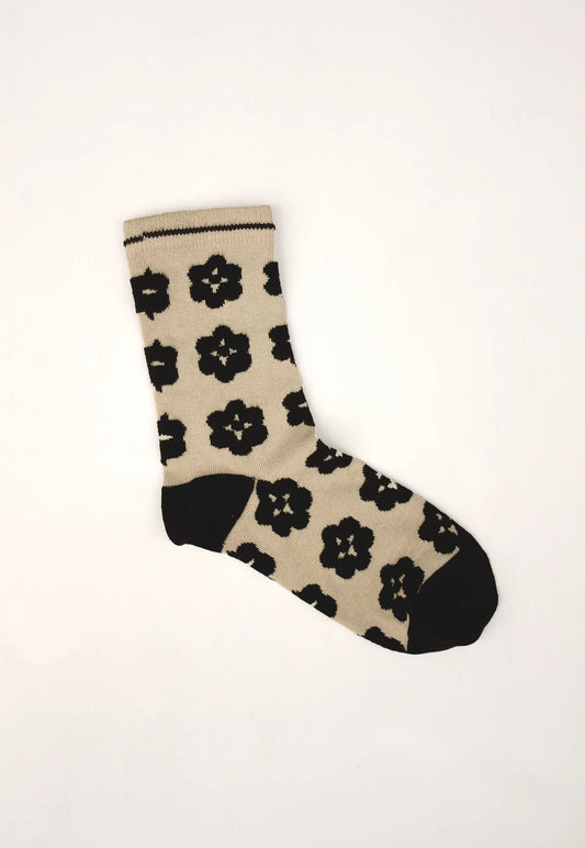 Nancybird Orakawa beige sock with black floral pattern on a white background.
