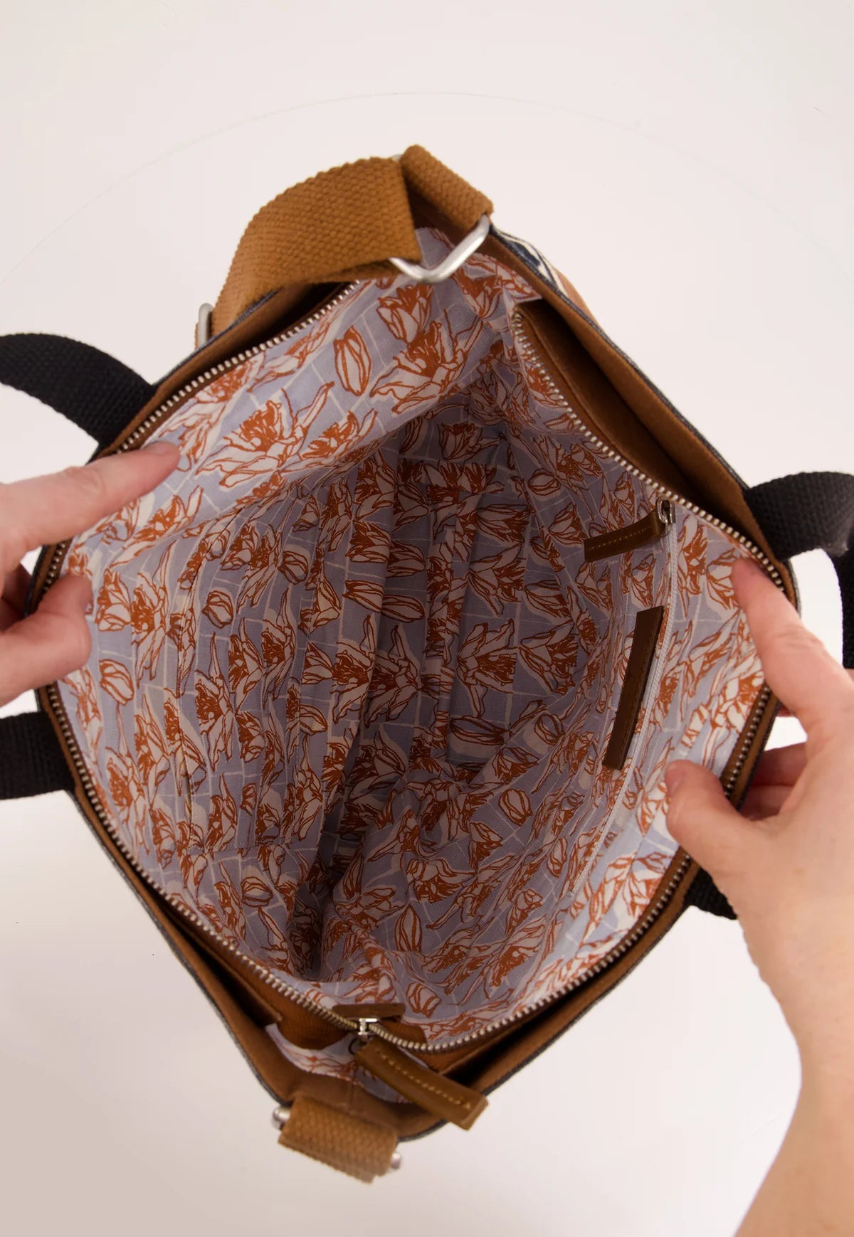 Nancybird brown shoulder bag featuring a front pocket printed with yellow lemons and a white floral pattern, set against a clean white background.