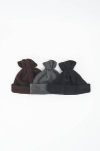 PCNQ brown wool woven beanie with gather at top that releases to create a snood, made in Japan.