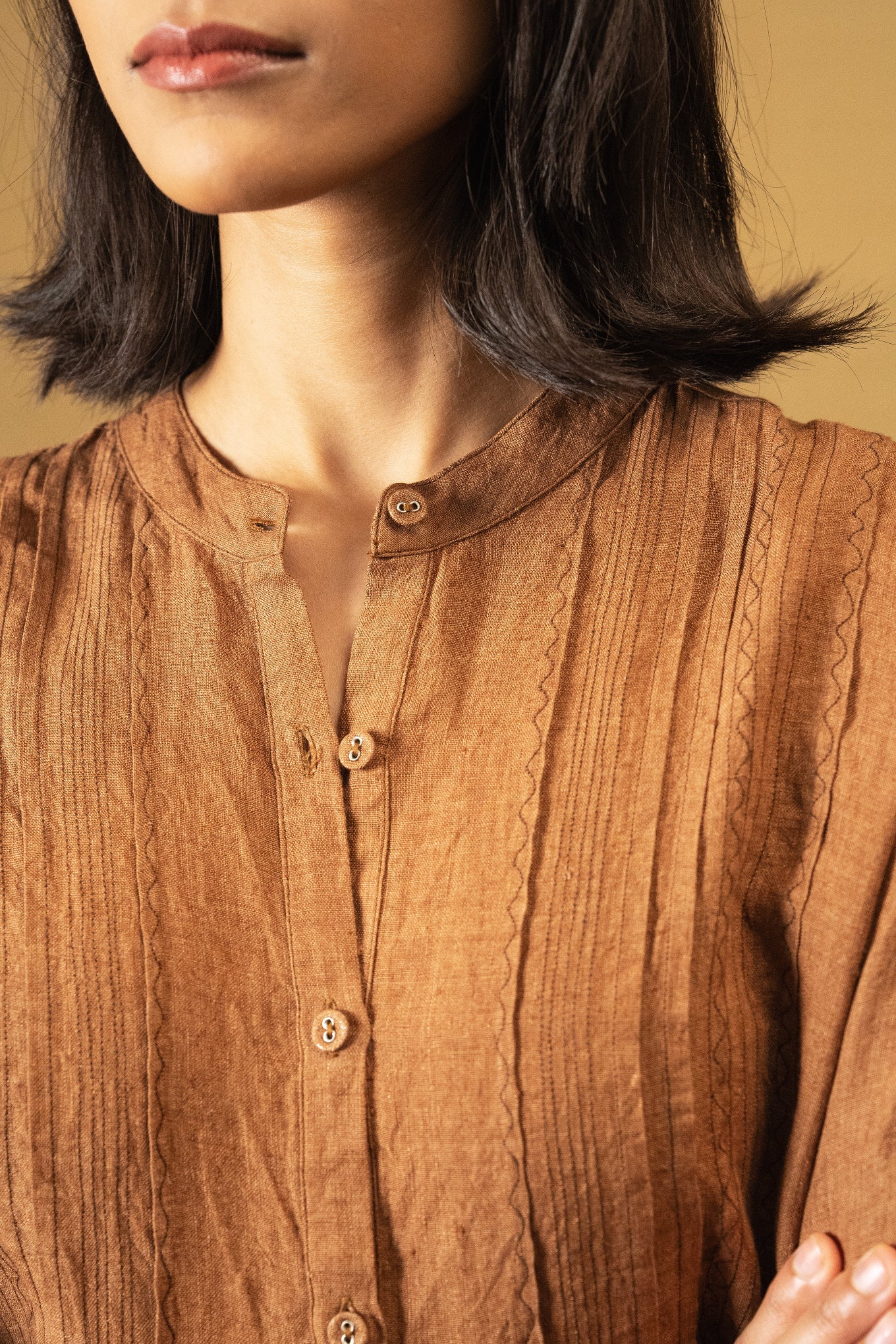DVE Apa button up collarless linen blouse in French beige tan brown with pintuck and embroidered details.
