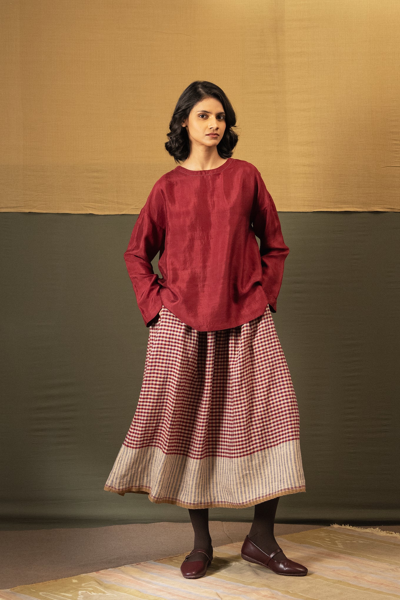 DVE Isha drawstring skirt in barn red linen gingham check with selvedge detail.