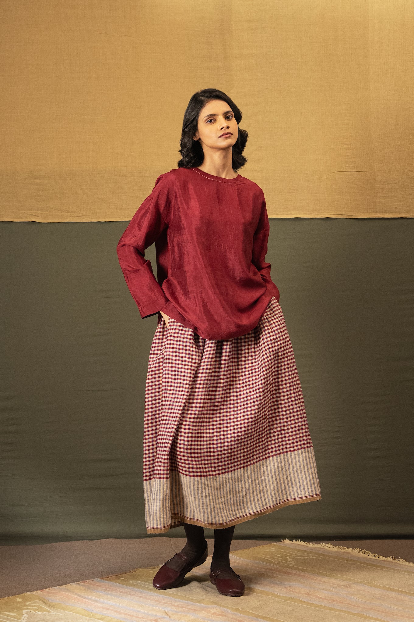 DVE Isha drawstring skirt in barn red linen gingham check with selvedge detail.
