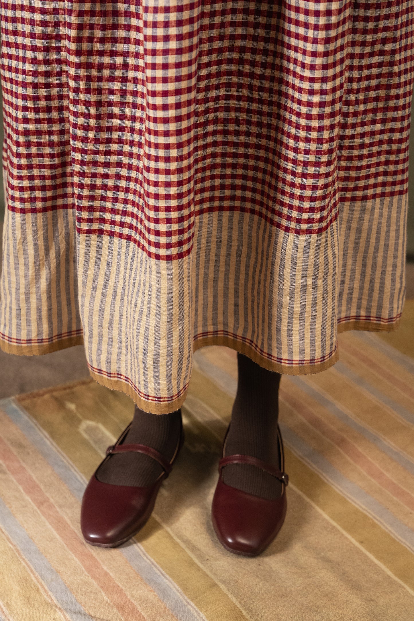 DVE Isha drawstring skirt in barn red linen gingham check with selvedge detail.