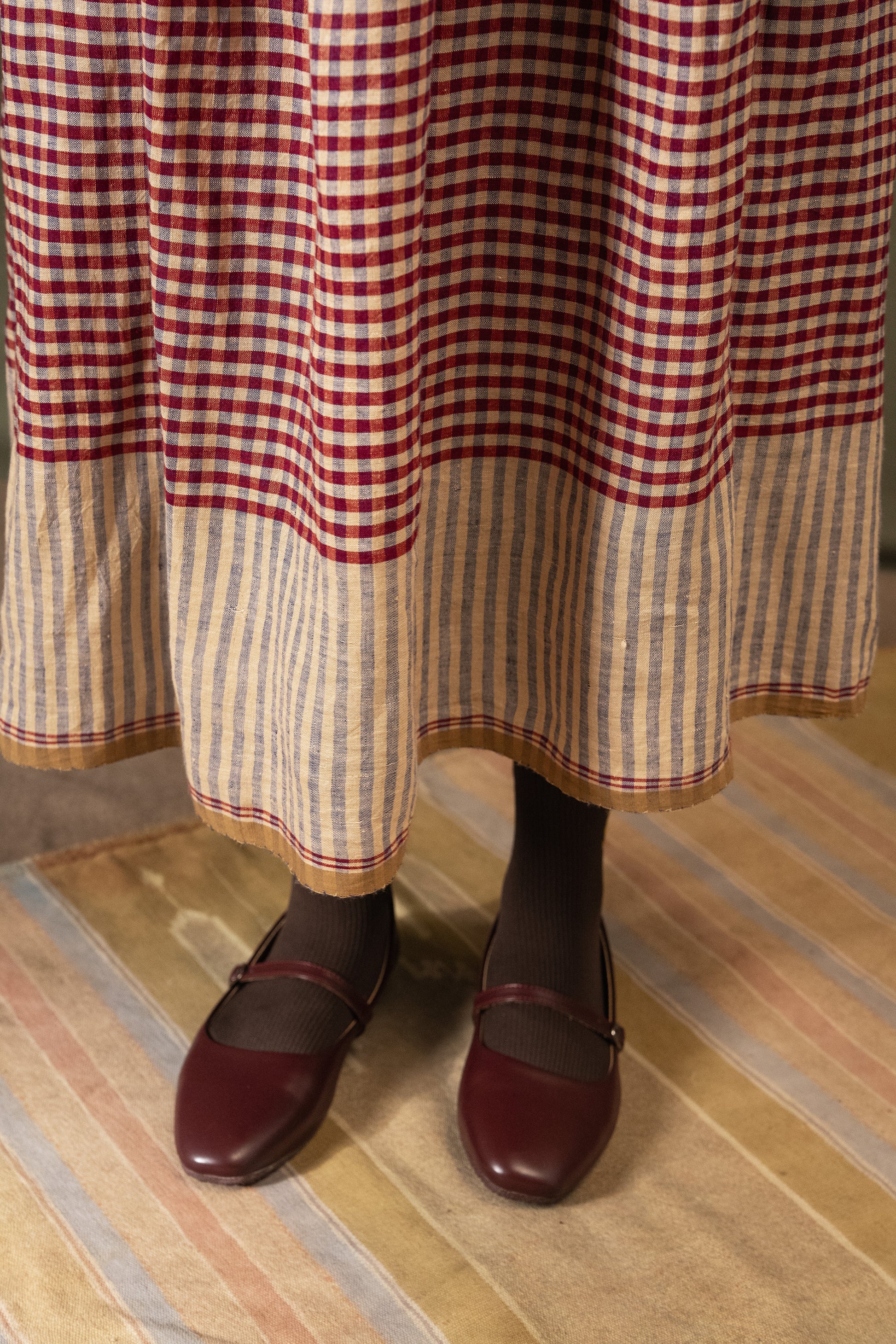DVE Isha drawstring skirt in barn red linen gingham check with selvedge detail.