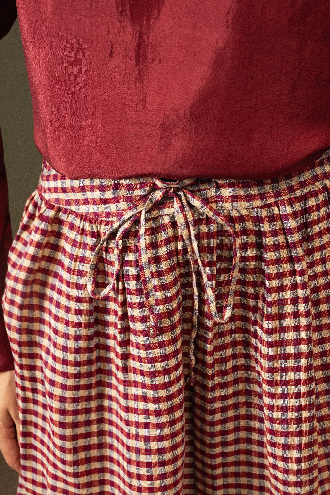 DVE Isha drawstring skirt in barn red linen gingham check with selvedge detail.