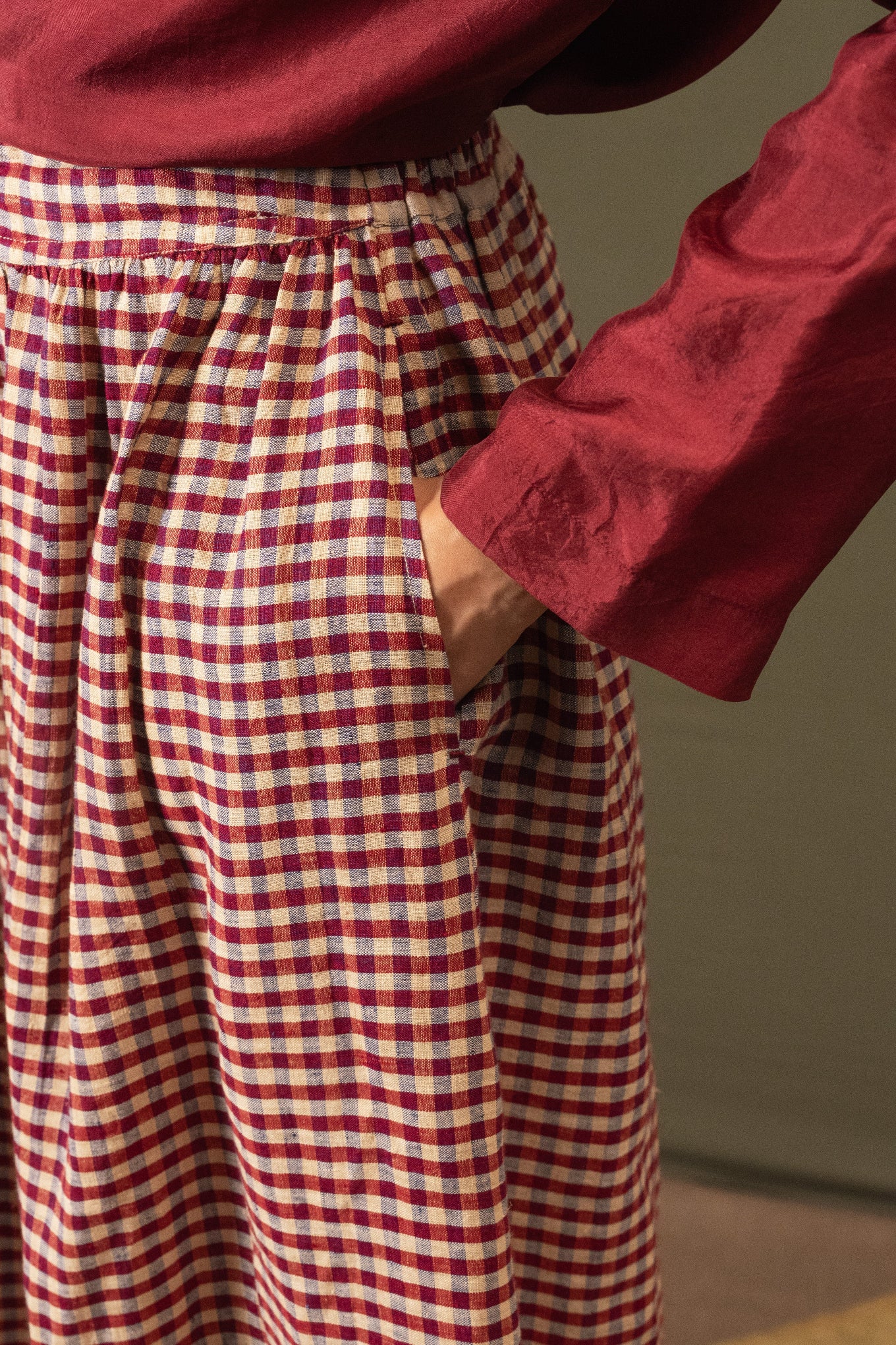 DVE Isha drawstring skirt in barn red linen gingham check with selvedge detail.