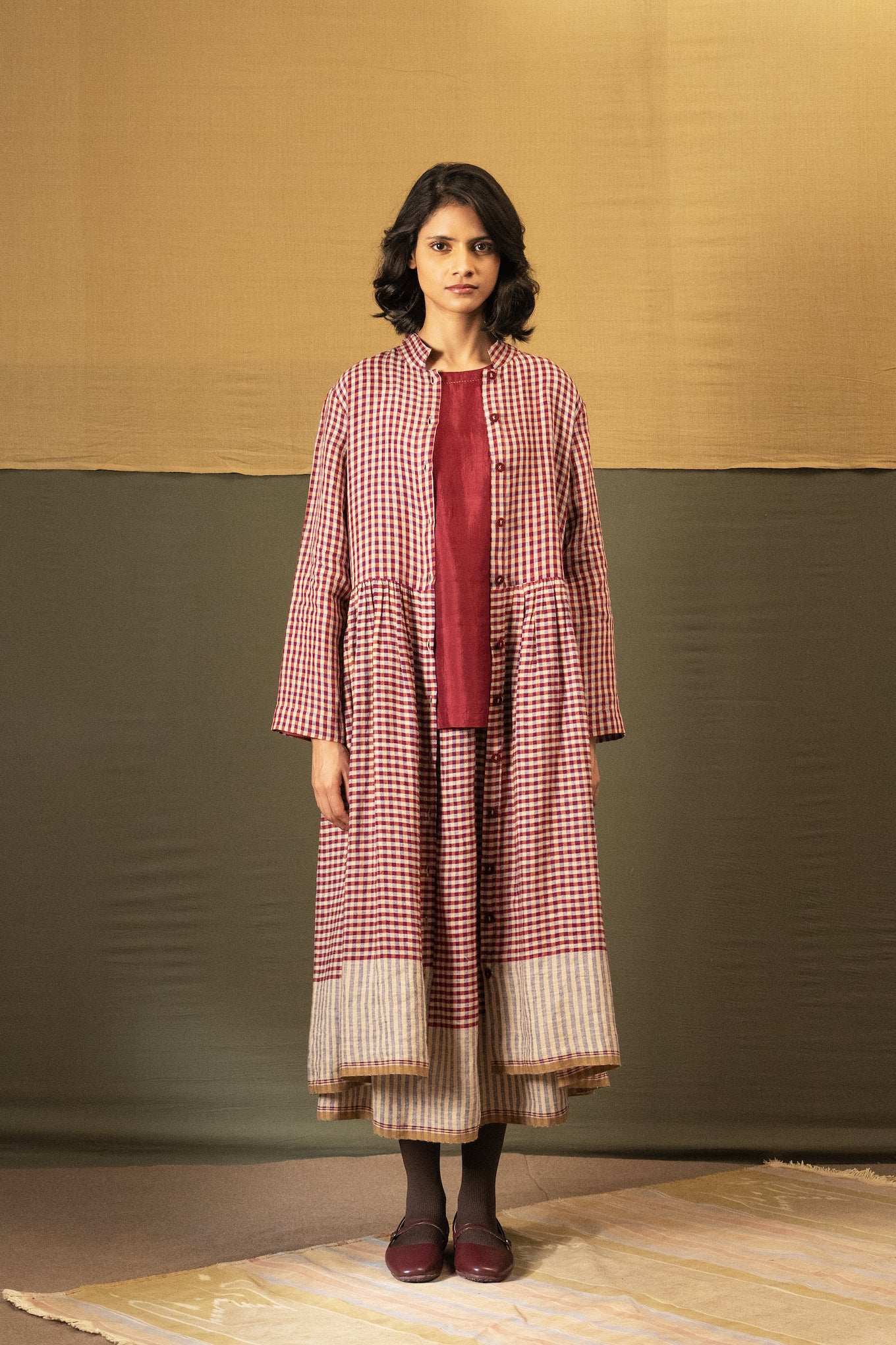 DVE Tara linen button up shirtdress in barn   red linen gingham check linen, worn over Santati silk top and Isha skirt.