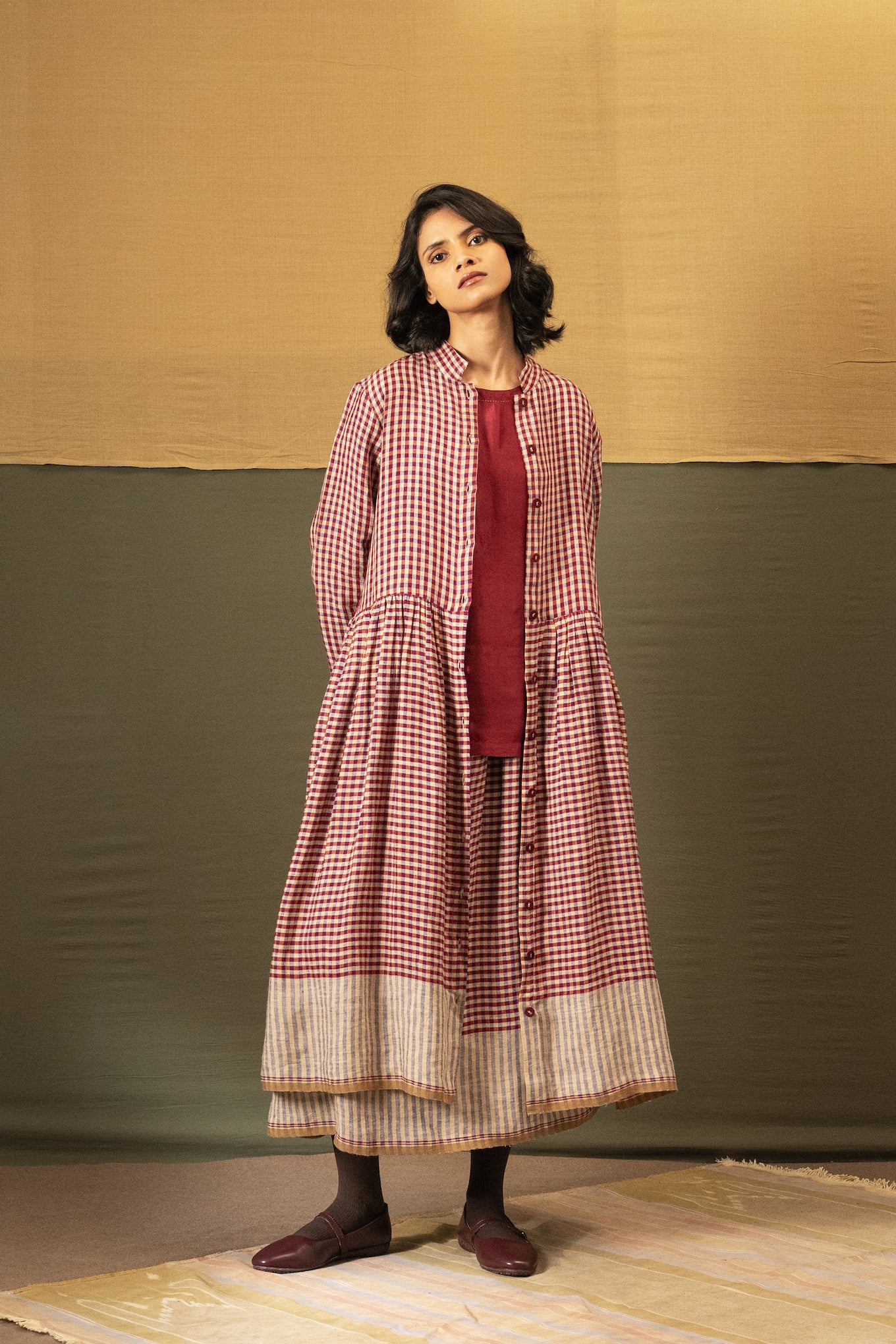DVE Tara linen button up shirtdress in barn   red linen gingham check linen, worn over Santati silk top and Isha skirt.