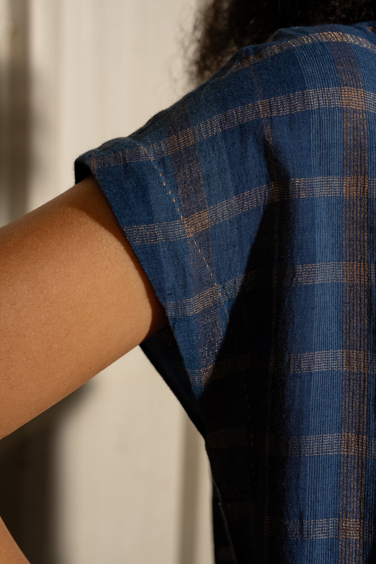 DVE Rayna dress in handloom indigo check cotton with subtle lurex stripe, cap sleeves and gathered skirt with side pockets.