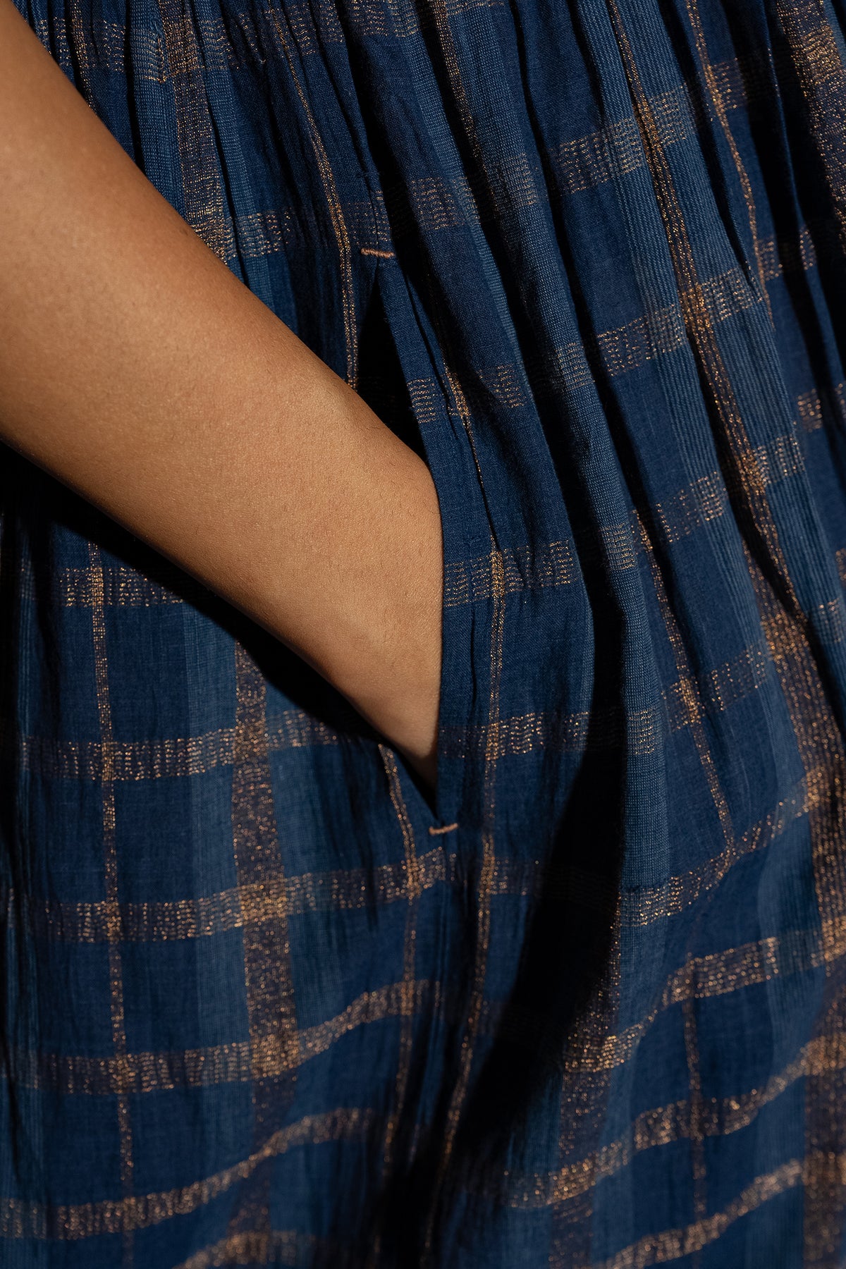 DVE Rayna dress in handloom indigo check cotton with subtle lurex stripe, cap sleeves and gathered skirt with side pockets.