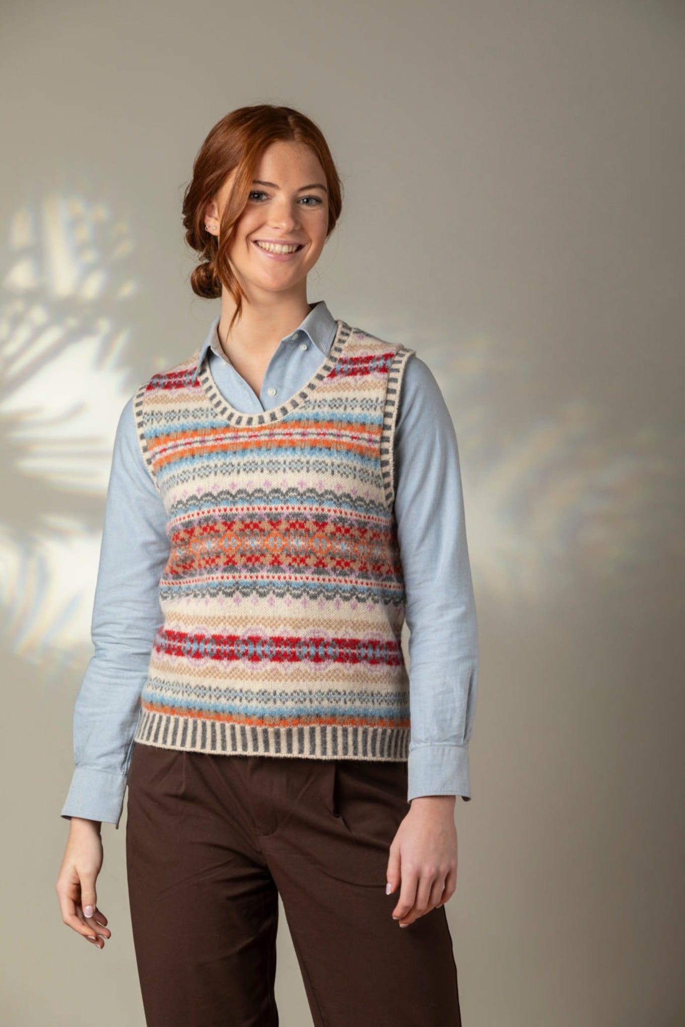 Eribe Westray fairisle vest in Mallaig, ecru, orange, crimson and sky blue.