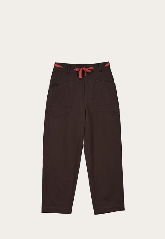 Nancybird Sera cotton linen blend brown pants with red accents on a light beige background.