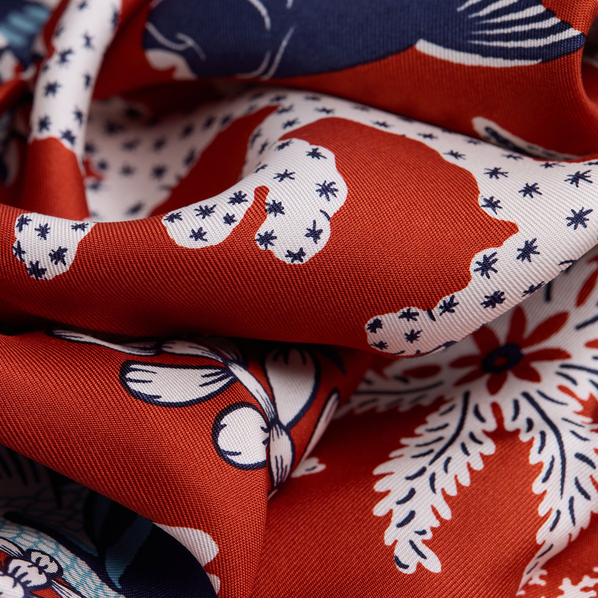 Inoui Editions Neptune pure silk carre, terracotta, blue and white scarf with marine life design on a white background.