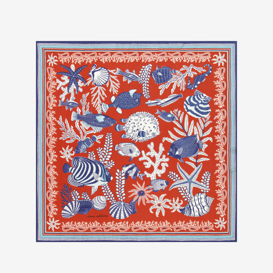Inoui Editions Neptune pure silk carre, terracotta, blue and white scarf with marine life design on a white background.