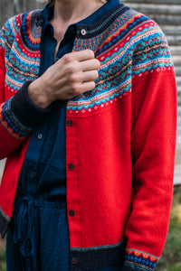 Eribe Alpine short cardigan in Crabapple, bright red with shades of blue and orange.