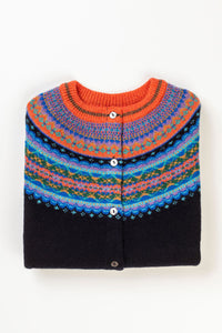 Eribe Alpine short cardigan in Enchanted, a vibrant combination of deep navy, with shades of blue and brilliant orange.
