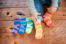 Load image into Gallery viewer, Solmate baby socks Prism, knit from recycled cotton yarn, two spares and a pair, purple blue green gold orange and red rainbow stripes.