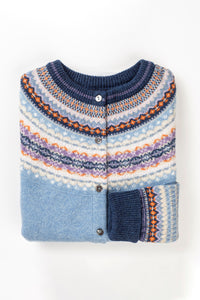 Eribé Alpine cardigan in Iris, soft blue and navy with highlights in orange and lavender lilac.