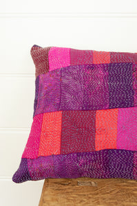 Juniper Hearth vintage silk kantha patchwork bolster cushion in shades of ruby, rose and amethyst.