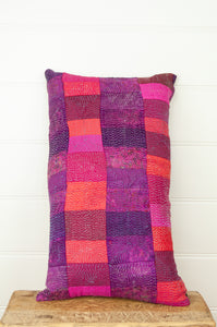 Juniper Hearth vintage silk kantha patchwork bolster cushion in shades of ruby, rose and amethyst.