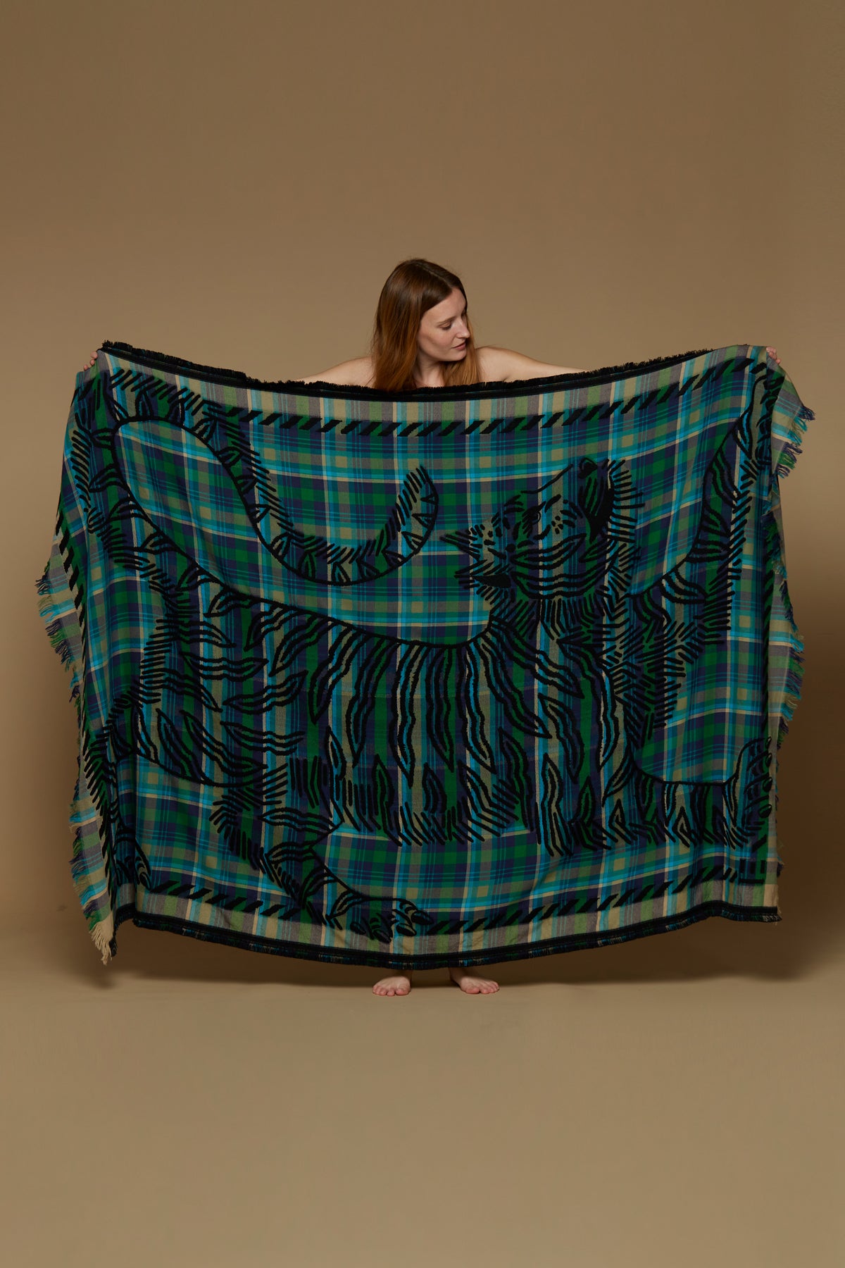 Inoui Editions wool throw, plaid in shades of blue and green with tiger silhouette in black.