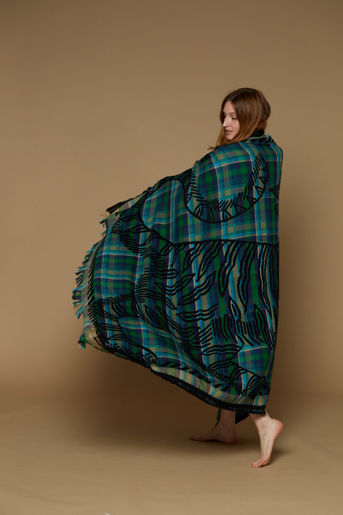 Inoui Editions wool throw, plaid in shades of blue and green with tiger silhouette in black.