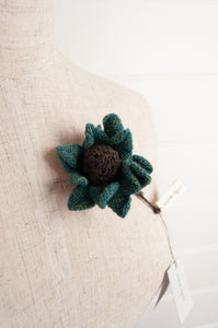 Sophie Digard brooch, made by hand in Madagascar, Asperule single flower crocheted in merino wool in deep turquoise with a chocolate brown centre.