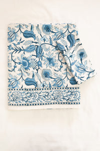 Ethically made artisan block print pure cotton table cloth, shades of blue on white floral design with border.