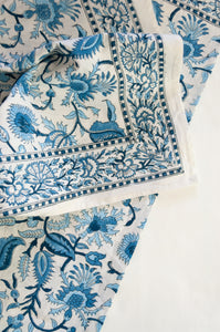 Ethically made artisan block print pure cotton table cloth, shades of blue on white floral design with border.