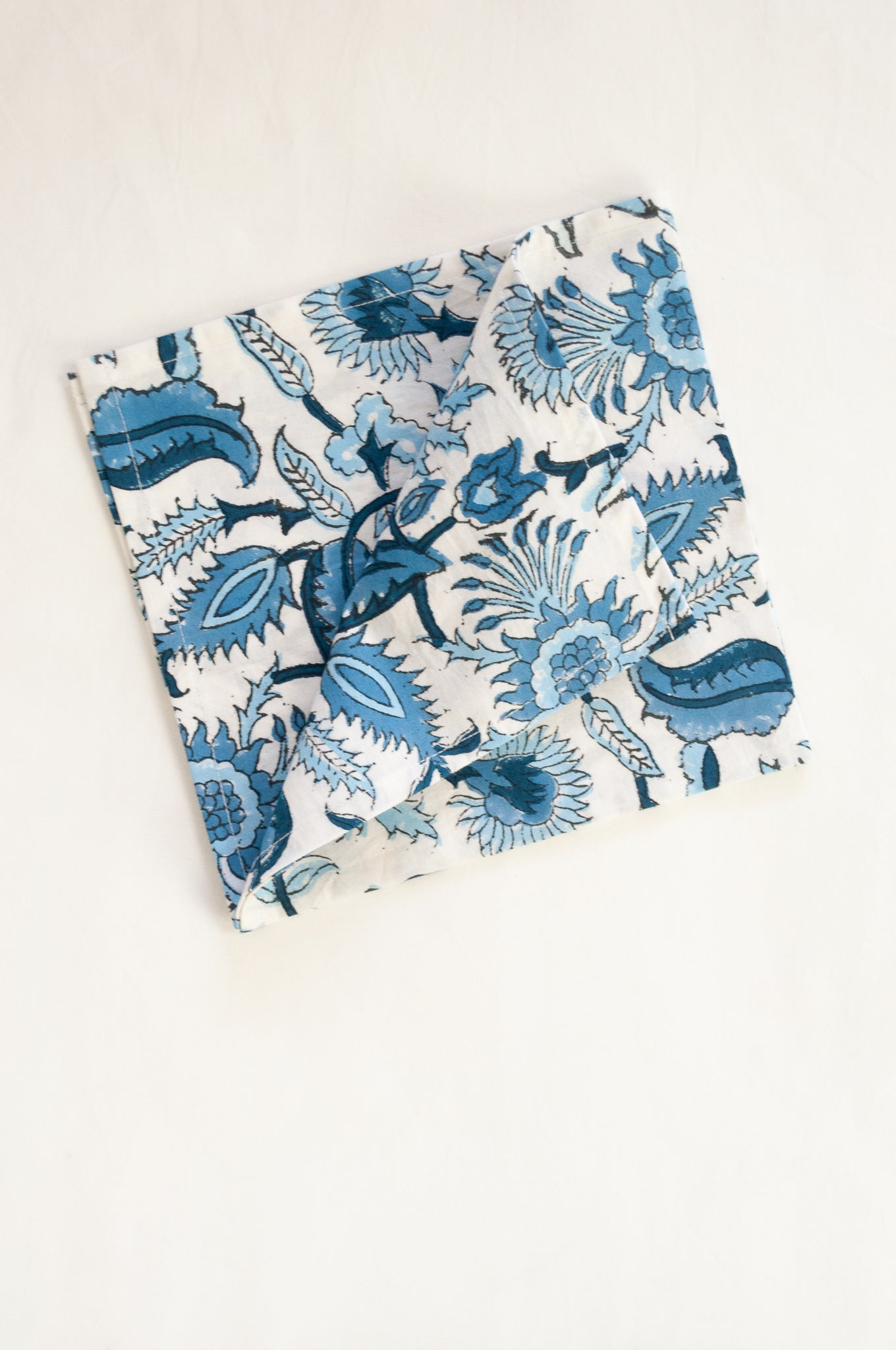 Ethically made artisan block print pure cotton napkin set, shades of blue on white floral design.