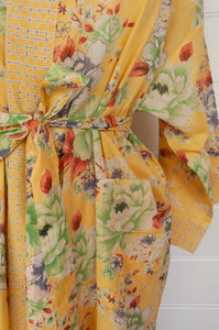 100% fine cotton voile kimono gown, screen printed by hand, peony floral print in shades of green, white, orange and grey on a butter yellow background, contrast trim. Ethically made.