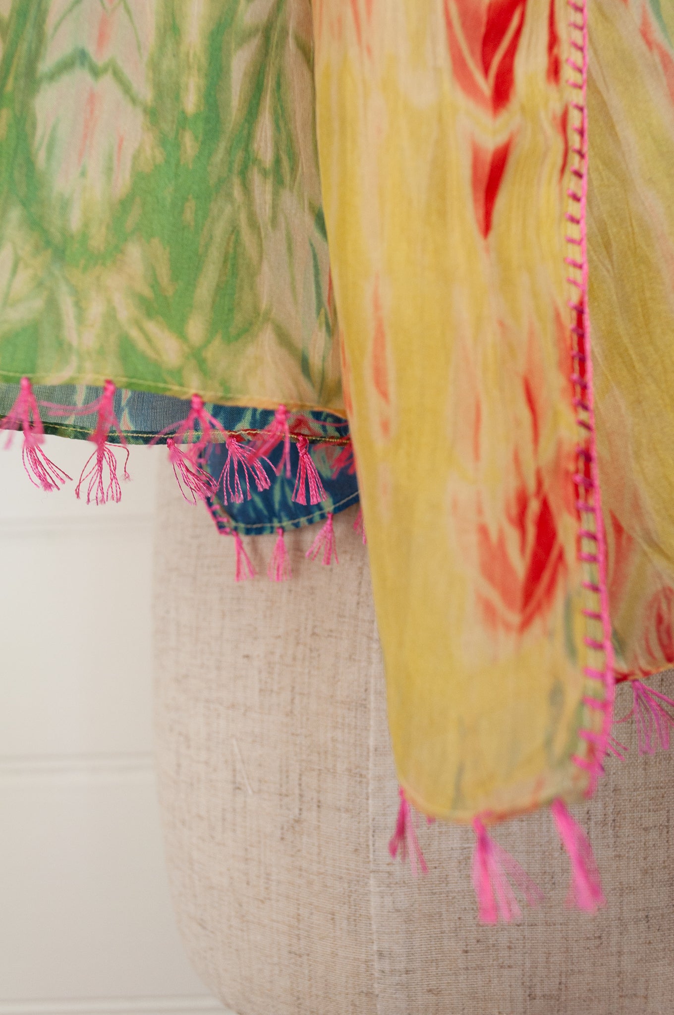 Neeru Kumar 100% silk shibori dyed scarf in lemon, lime, aqua and blue with highlights in vermilion red, tassels and edge stitching in pink.