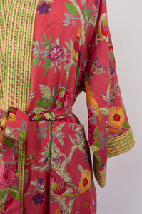 Cotton voile kimono robe dressing gown in coral bird print with yellow trim, close up.