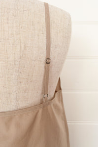Below knee length cotton voile full slip with adjustable straps and side slits. In natural.