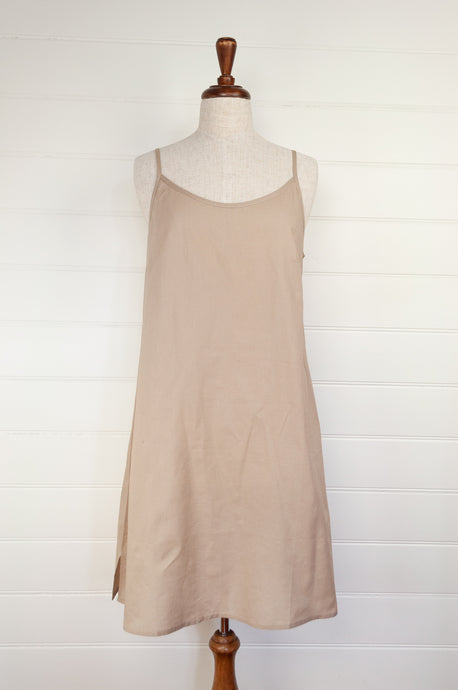 Below knee length cotton voile full slip with adjustable straps and side slits.