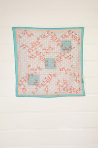 Anna Kaszer carré fine cotton neck square scarf, subtle fine geometric pattern in aqua and coral red, overlaid with tiny flowers.