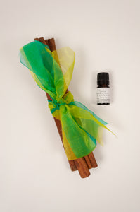Juniper Hearth cinnamon stick bundles tied with brightly coloured organza ribbons. And sweet cinnamon oil.