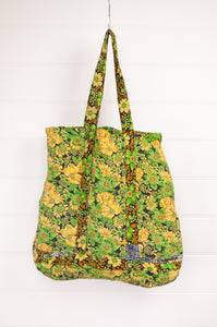 Vintage kantha tote bag with internal pocket, bright lime green and yellow daisies on black background.