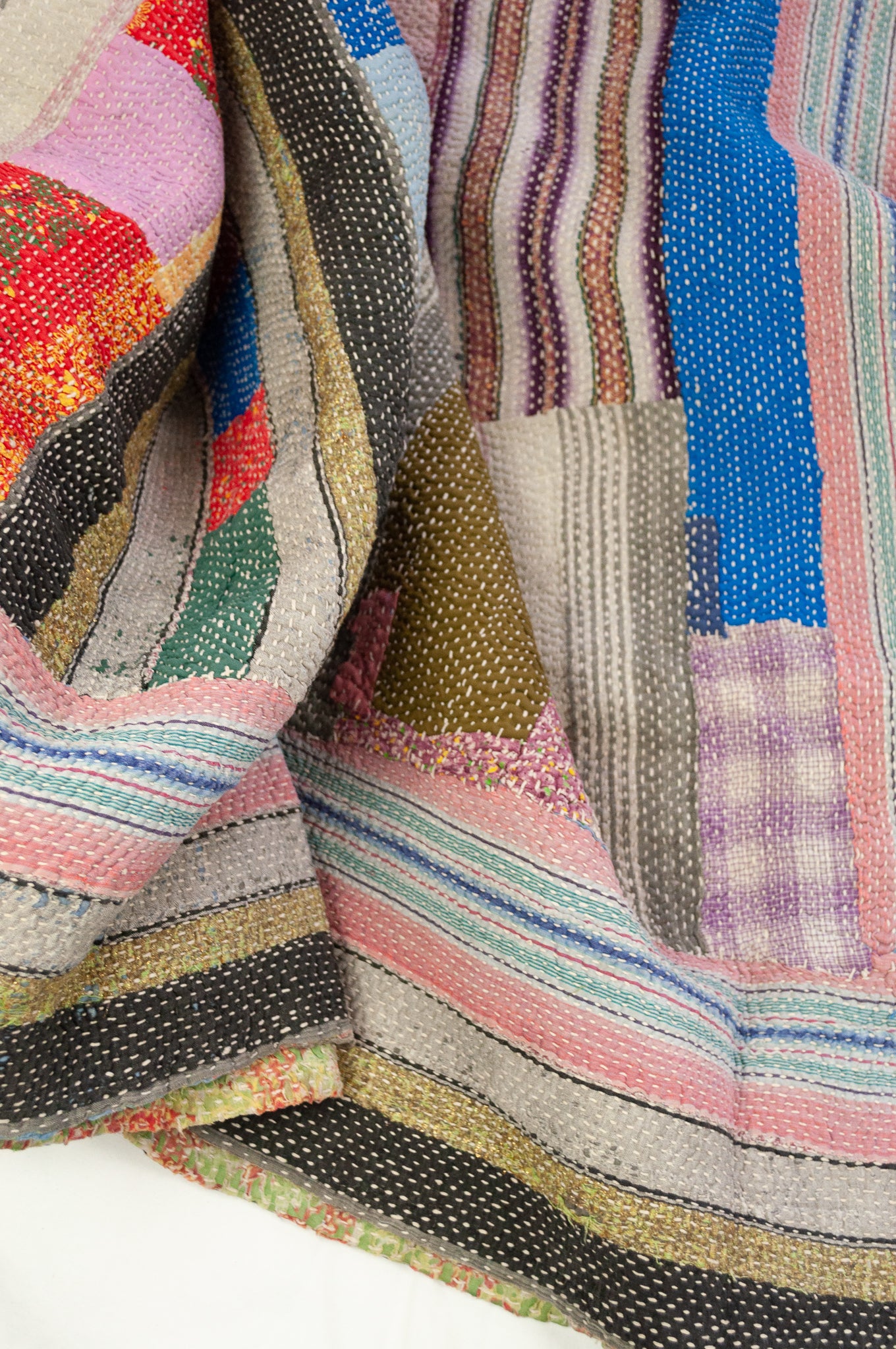Vintage kantha quilt, heavier weight Mayra, striped patchwork in black and olive green with bright pops of colour, soft vintage green and red floral on reverse.