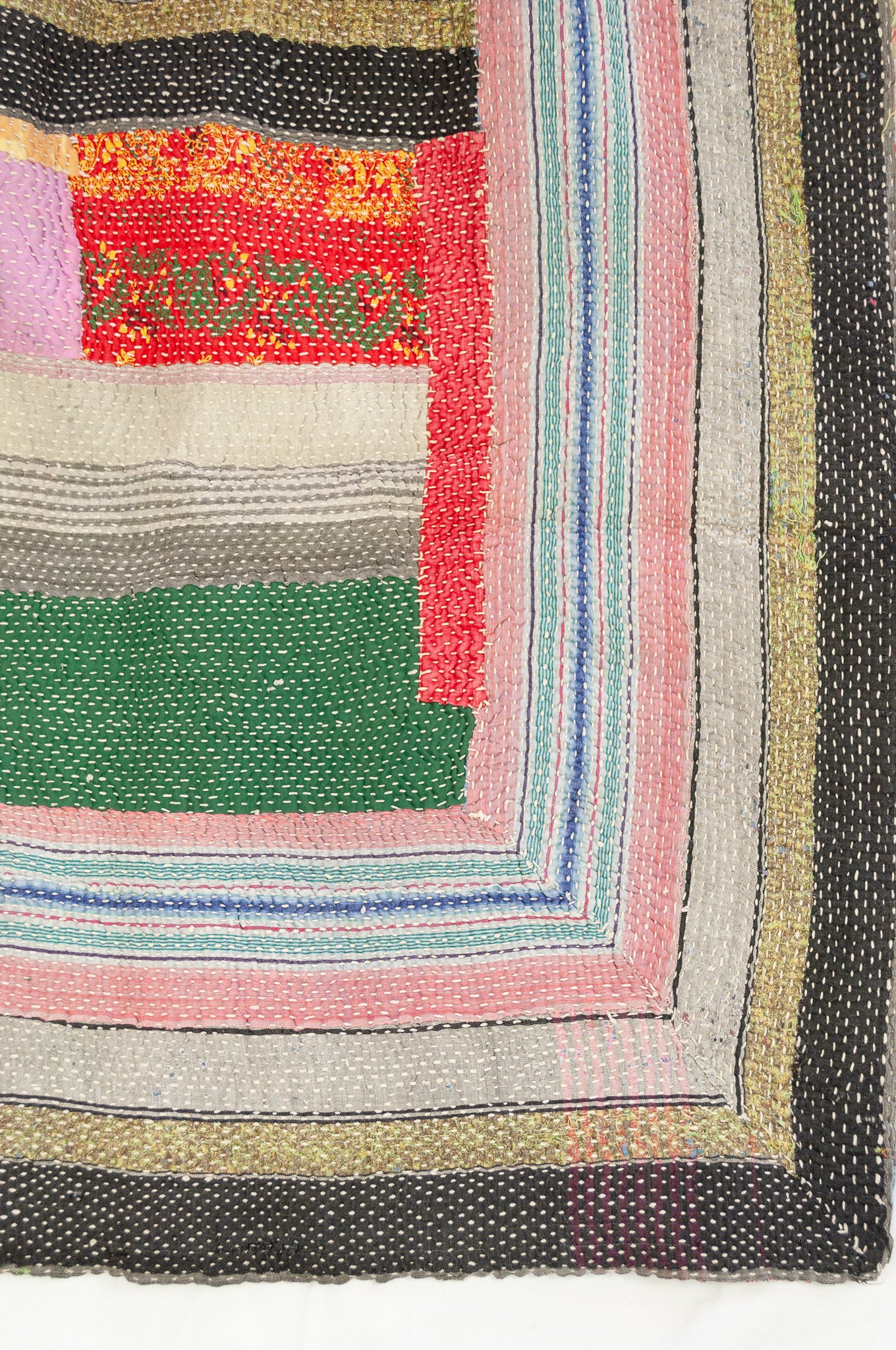 Vintage kantha quilt, heavier weight Mayra, striped patchwork in black and olive green with bright pops of colour, soft vintage green and red floral on reverse.