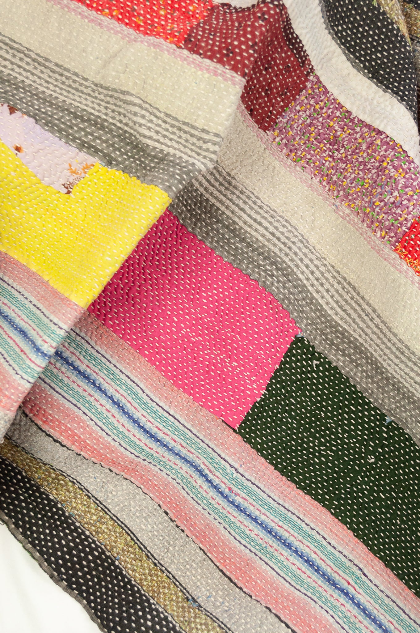Vintage kantha quilt, heavier weight Mayra, striped patchwork in black and olive green with bright pops of colour, soft vintage green and red floral on reverse.