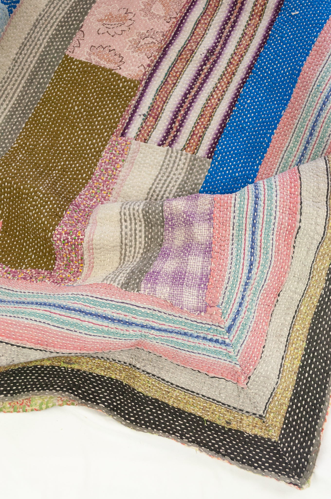 Vintage kantha quilt, heavier weight Mayra, striped patchwork in black and olive green with bright pops of colour, soft vintage green and red floral on reverse.