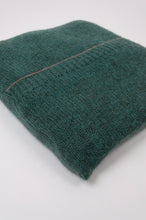Load image into Gallery viewer, Juniper Hearth baby yak poncho in Opal, a shade of blue green (close up, in pouch).