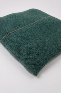 Juniper Hearth baby yak poncho in Opal, a shade of blue green (close up, in pouch).