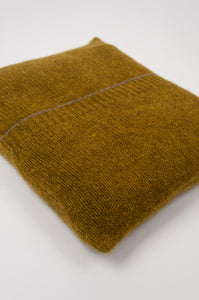 Juniper Hearth baby yak wool poncho in Weed, a deep yellow olive green shade (close up in pouch).