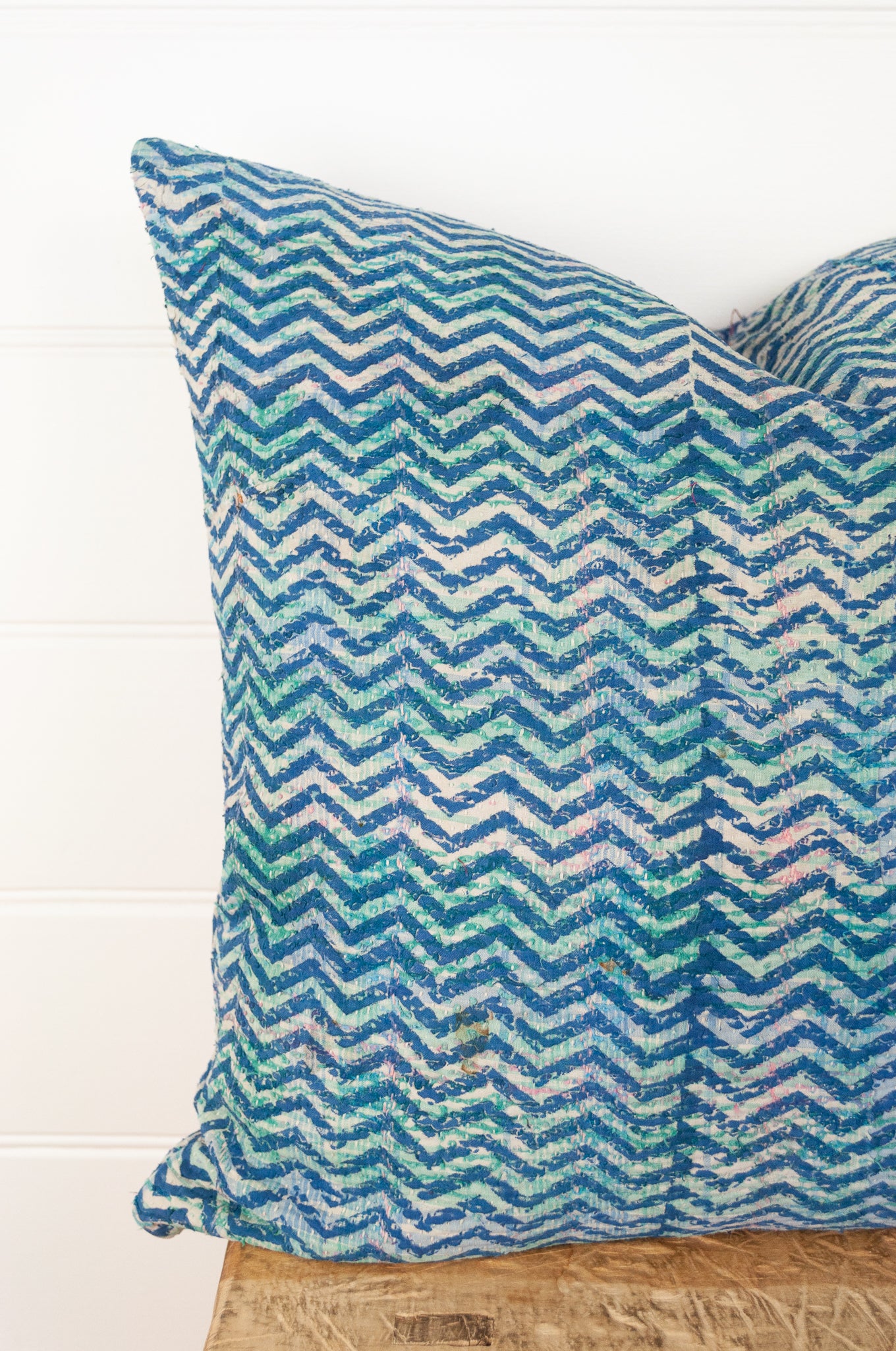 Vintage kantha quilt cushion, overdyed with blue and white blockprint chevron stripe pattern with red highlights.