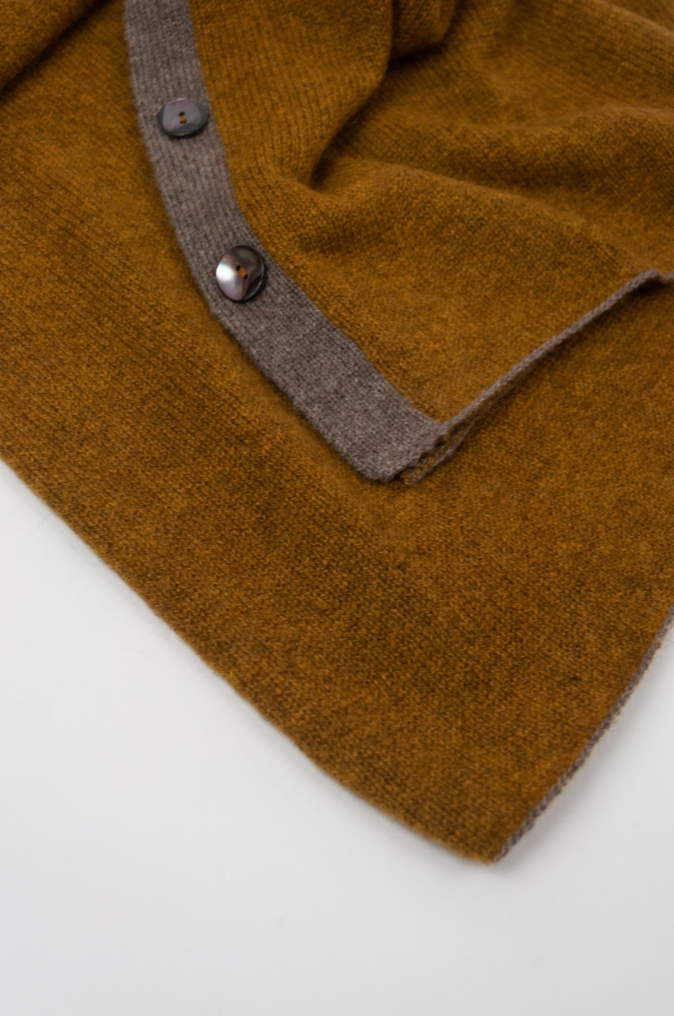 Juniper Hearth baby yak wool poncho in Maize, a deep mustard gold (close up).