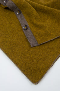 Juniper Hearth baby yak wool poncho in Weed, a deep yellow olive green shade (close up).