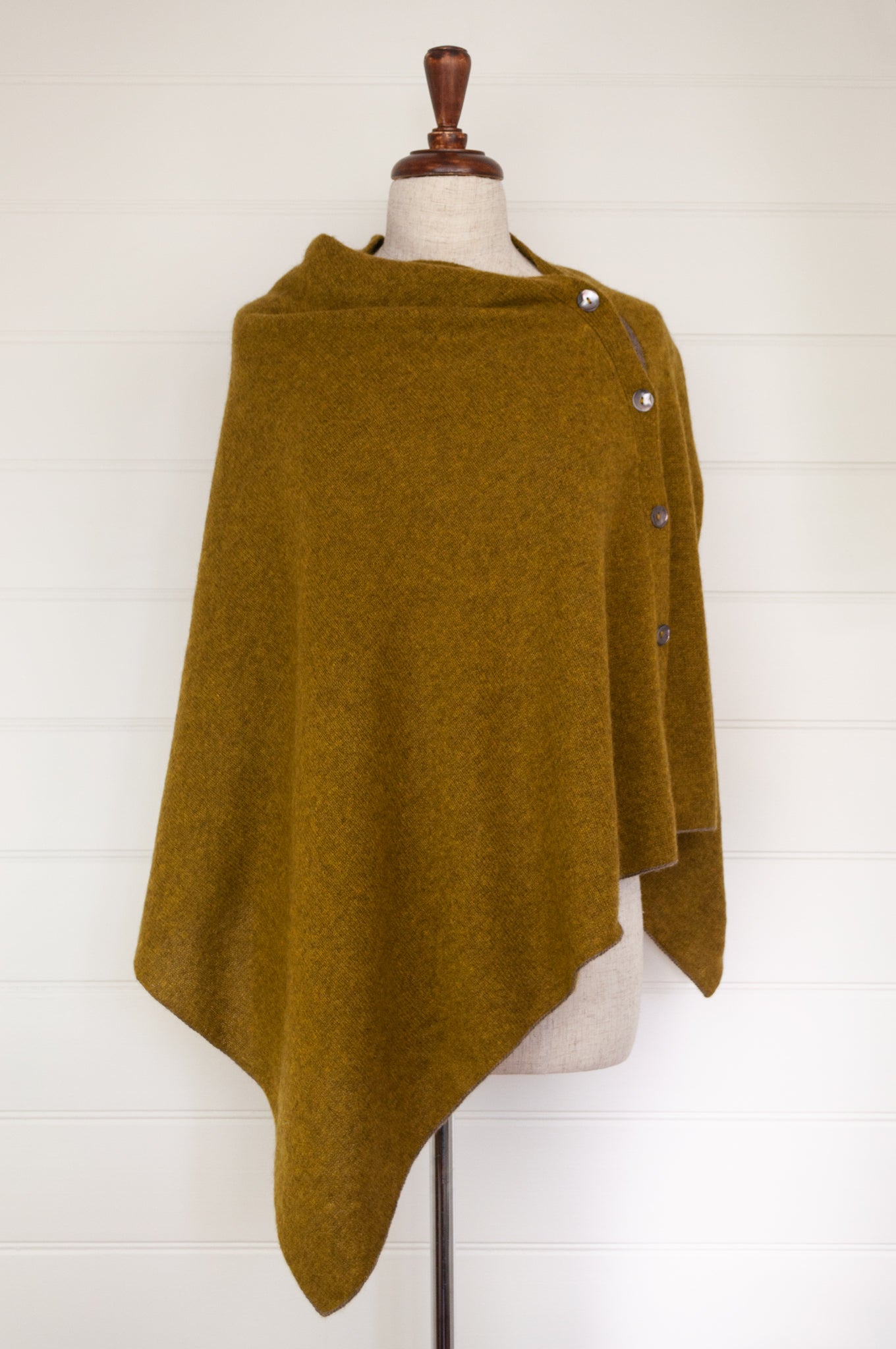 Juniper Hearth baby yak wool poncho in Weed, a deep yellow olive green shade.